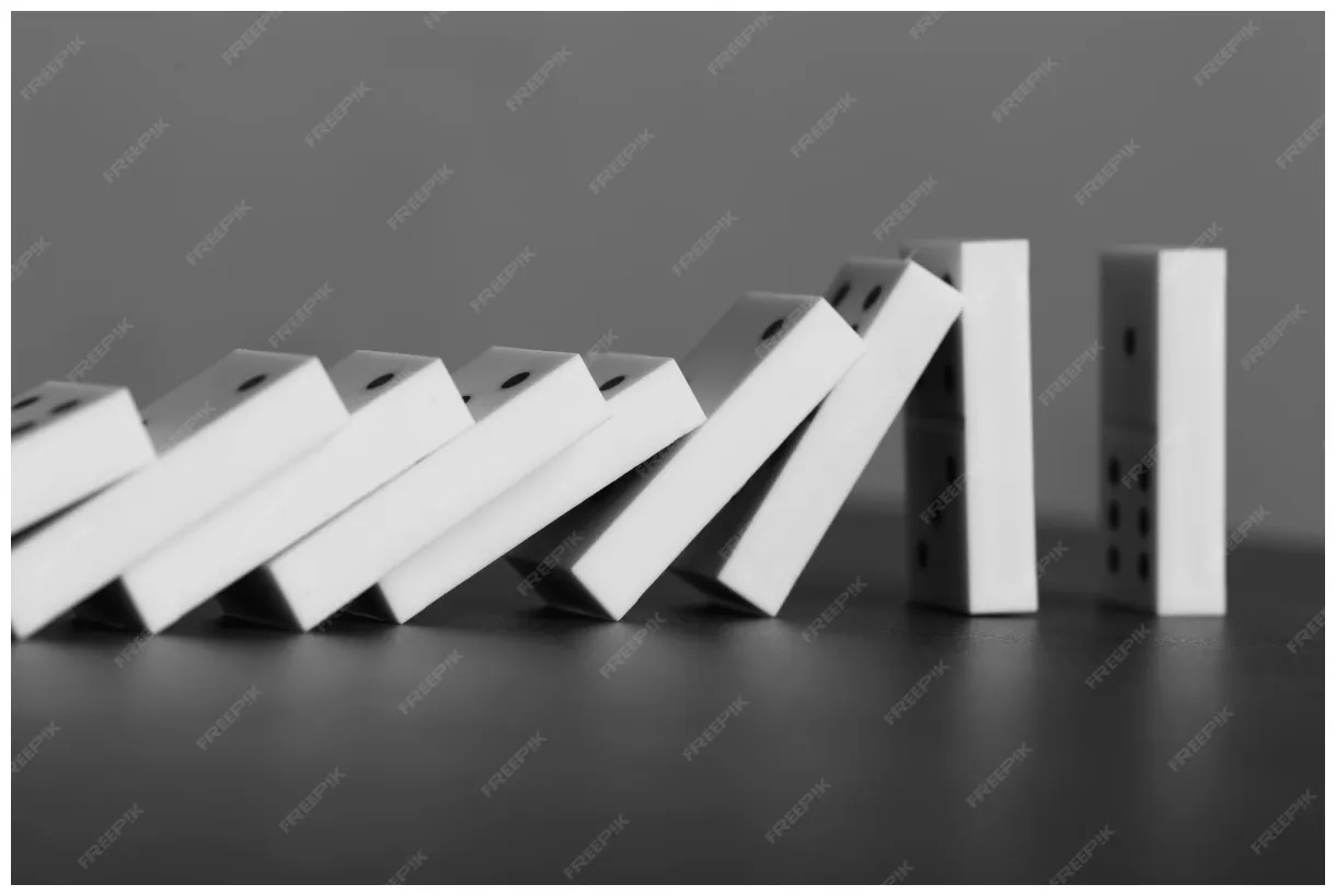Premium dominoes falling on gray