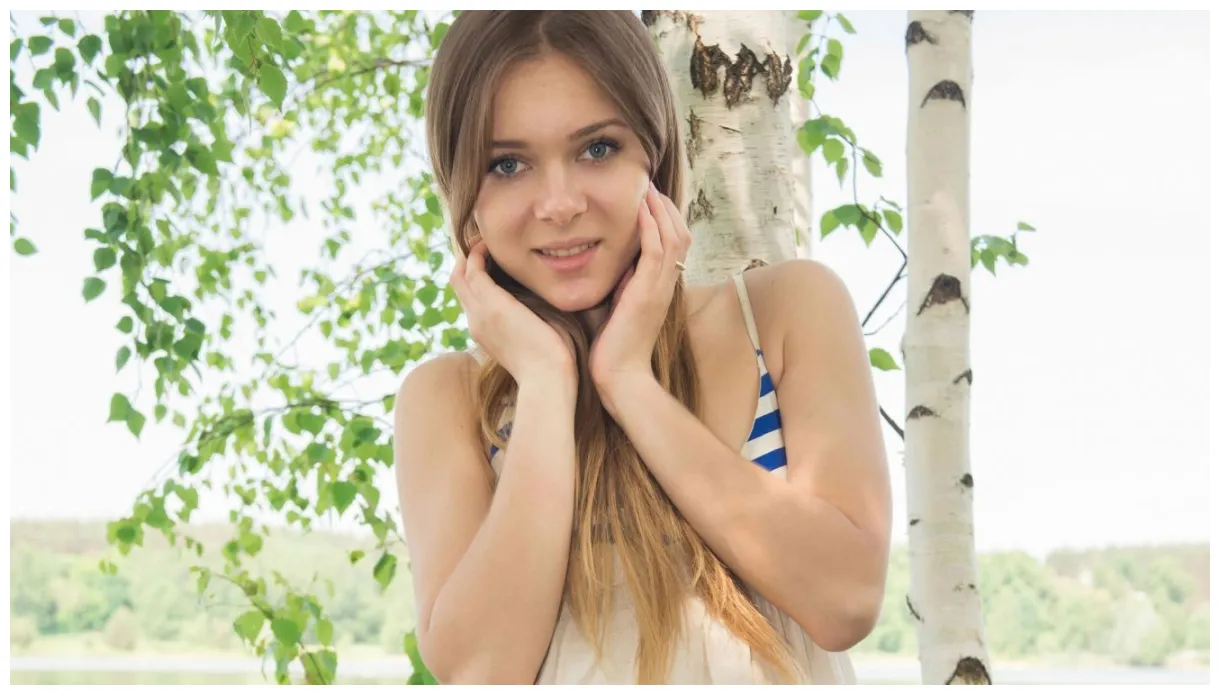 Woman in blue and white stripe tank top smiling