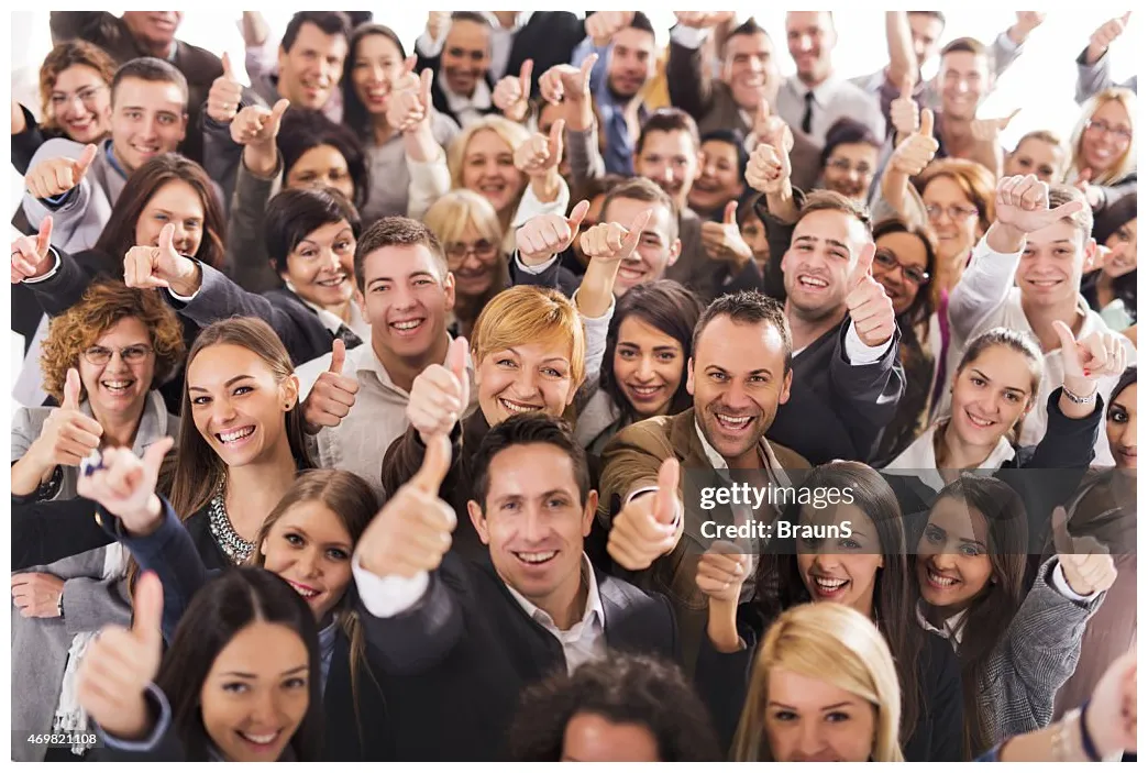 Large group of people smiling and giving thumbs up high-res