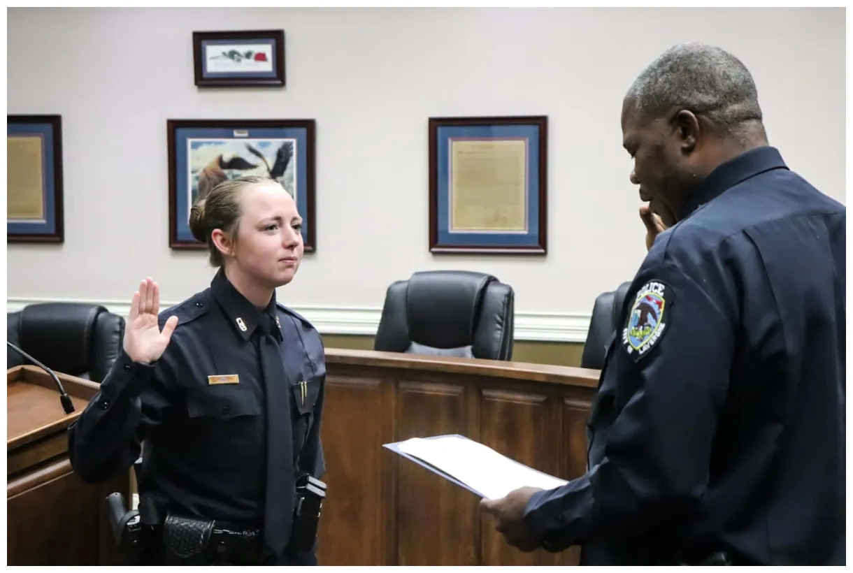 Download A police officer holds a shield ready for duty. | Wallpapers.com